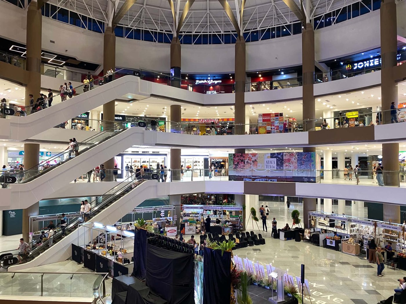 Shoppers on the escalators and mall floors of Ayala Center Cebu